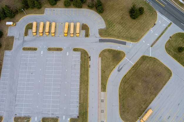An overhead shot of a modern electric vehicle charging station equipped with solar panels and battery storage systems. The station features multiple charging stalls, with various types of electric vehicles actively charging.