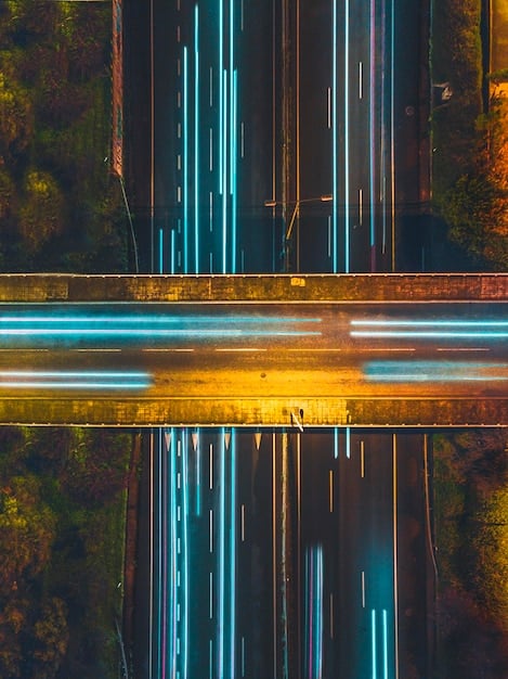 A close-up view of road sensors embedded in the asphalt of a highway, highlighting the technology that collects real-time traffic data.