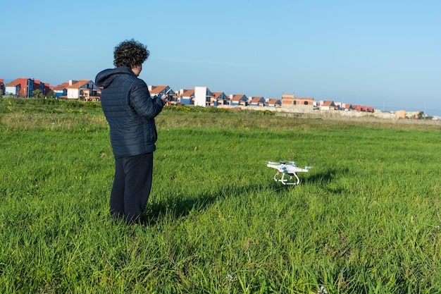 Close-up of a drone landing on a designated pad in a suburban backyard, with a package securely attached. The background shows a typical American house with a manicured lawn.