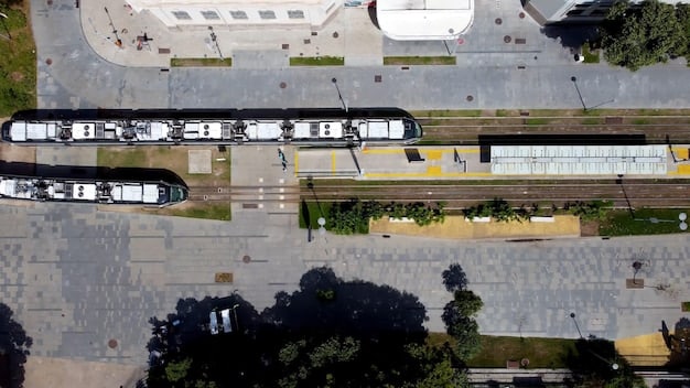 An aerial view of a modern urban transportation hub, featuring electric buses, light rail lines, and bike-sharing stations, all seamlessly integrated with pedestrian walkways and green spaces.