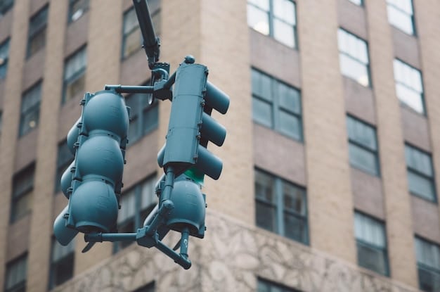 A close-up of a smart traffic light at an intersection, showing integrated sensors and cameras. The traffic light displays dynamic timing adjustments based on real-time traffic conditions. In the background, a screen displays data visualizations of traffic flow and AI analysis.