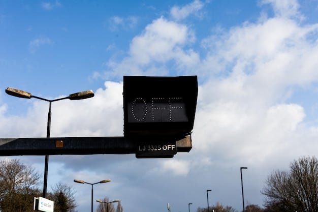 A close-up of a high-tech air quality sensor installed on a streetlight pole in a city, displaying real-time data on a small screen. The background shows blurred city traffic.