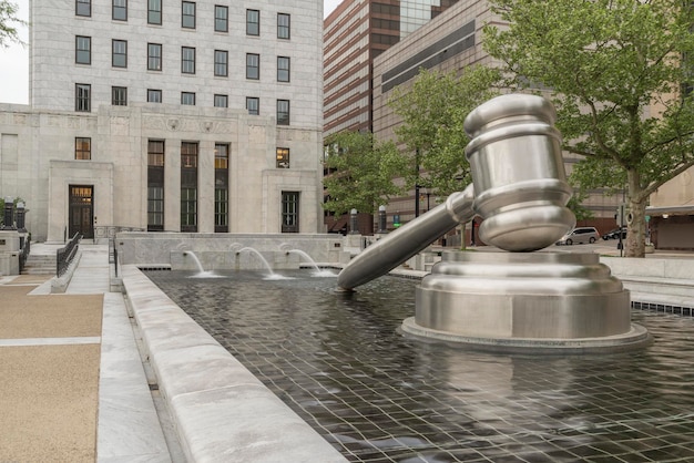 A gavel resting on a stack of legal documents, with a blurred background showing a smart city control center, representing the intersection of law and technology in smart city governance.