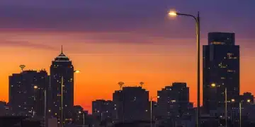 Smart LED streetlights illuminating a modern city at dusk, showcasing energy efficiency and urban connectivity.