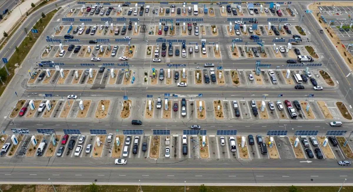 Extensive network of EV charging stations at a US highway rest stop with solar panels.
